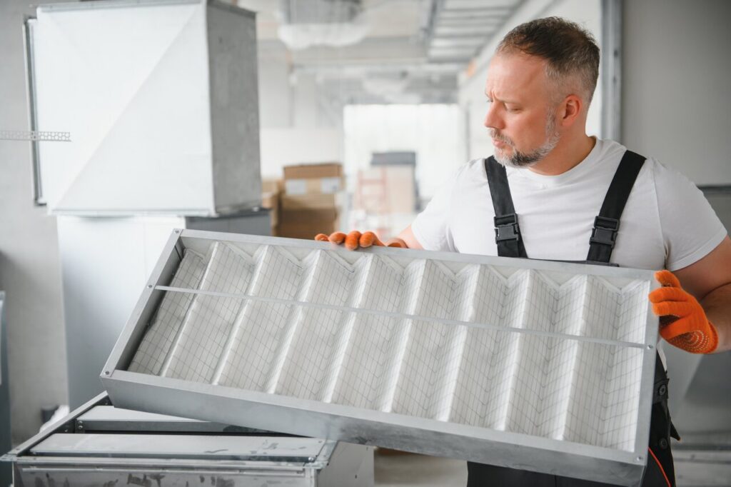 rsz a male worker holds an air filter for air conditio 2023 11 27 05 07 45 utc copy
